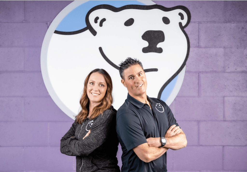 Katie Hall and Tim Hall of Silver Bear Swim Academy in front of the Silver Bear logo, highlighting learn-to-swim programming and franchise ownership.